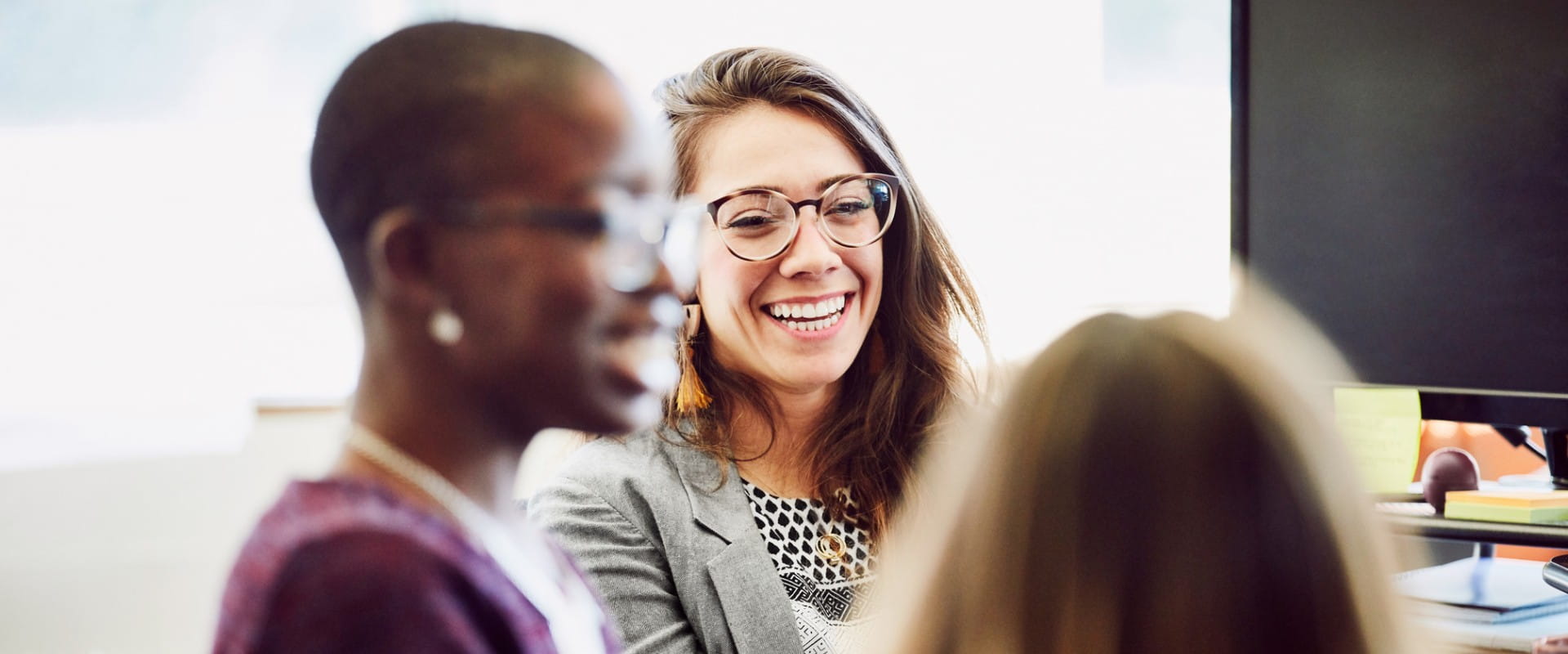 Colleagues smiling during a meeting.