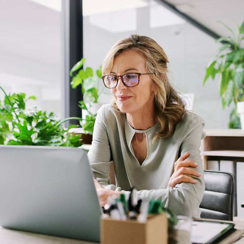 Associate reading their laptop screen in an office