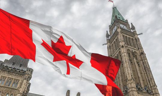 Canada flag flying outside the Parliament buildings in Ottawa.
