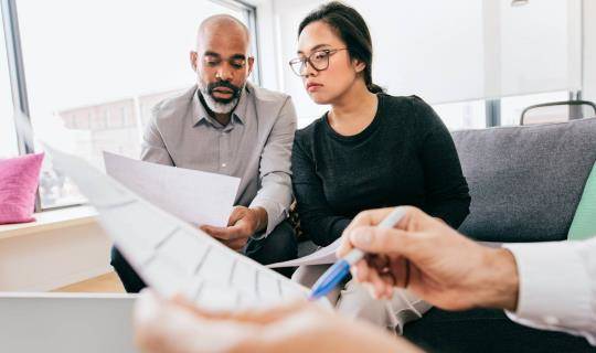 Team members reviewing a document in a casual meeting space