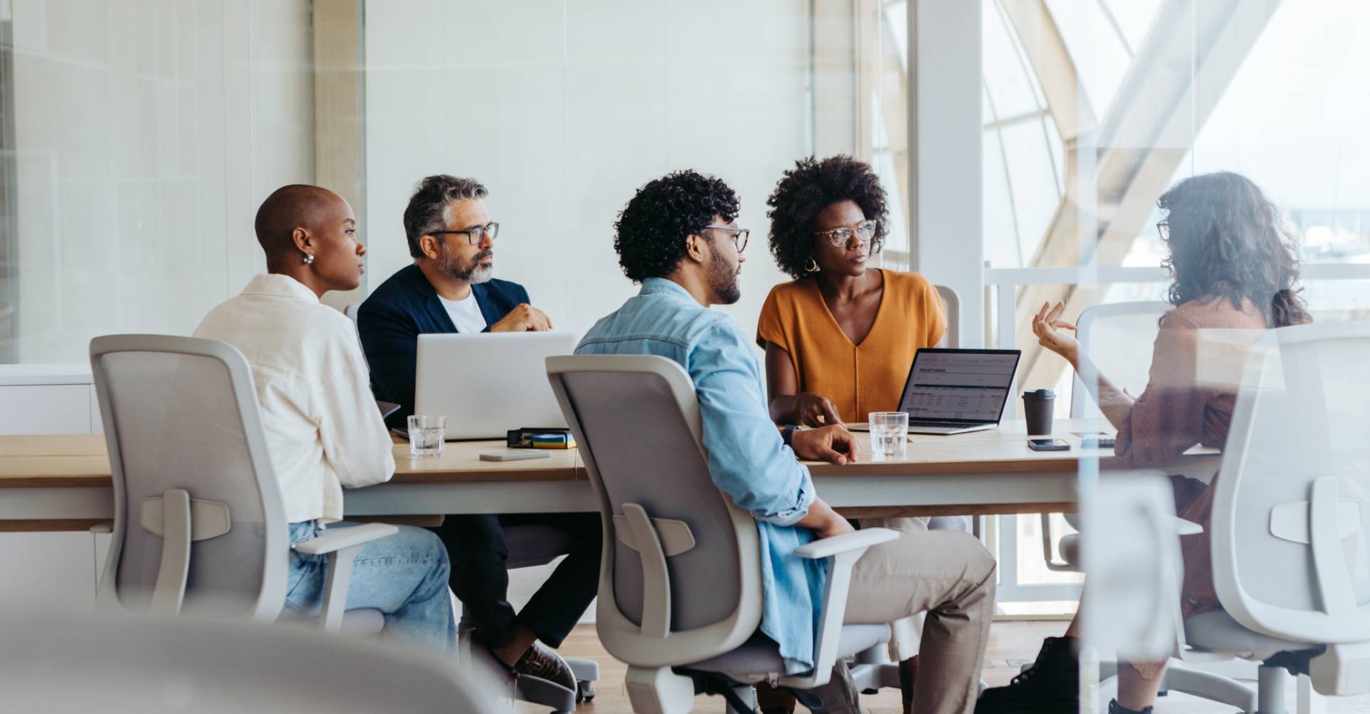 Group of professionals collaborates and brainstorm ideas in a modern office.
