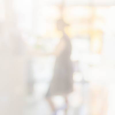 A blurry photo of a person at the counter in a pharmacy