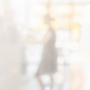 A blurry photo of a person at the counter in a pharmacy