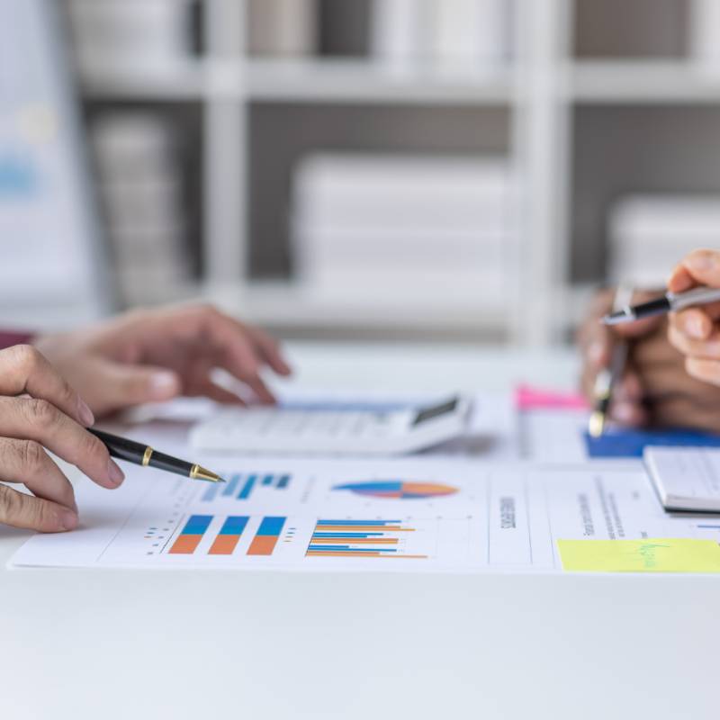 Business meeting reviewing charts and data.