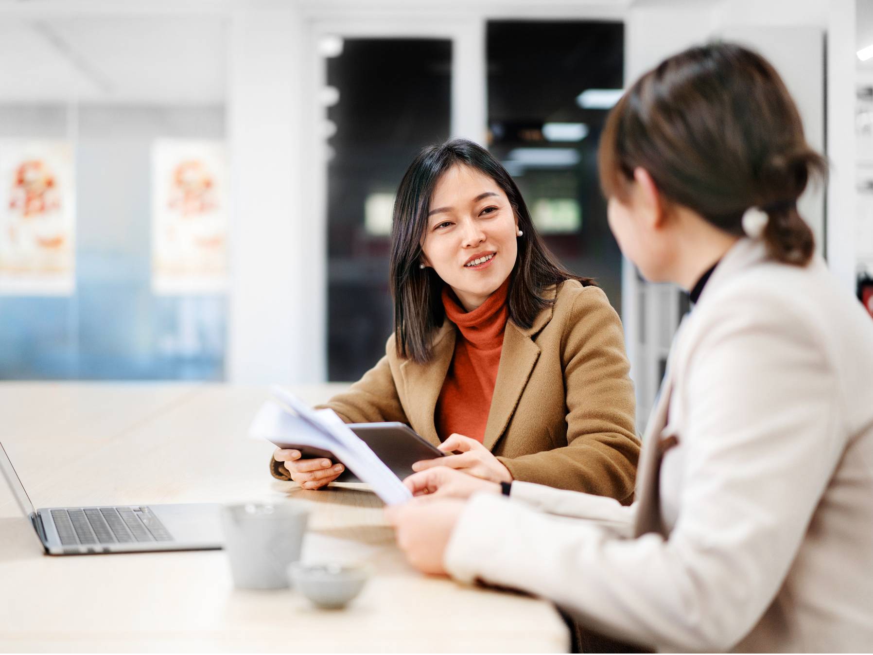 Colleagues in discussion around a laptop