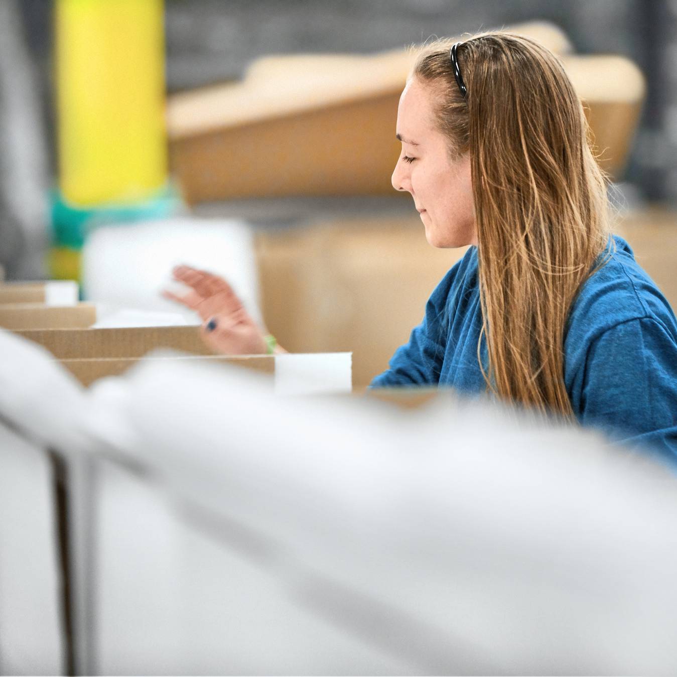 An associate adding to a shipping package
